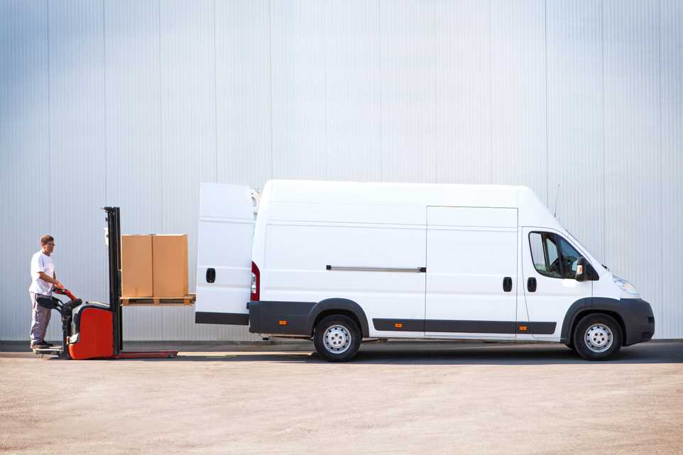 Courier delivering parcels in white van