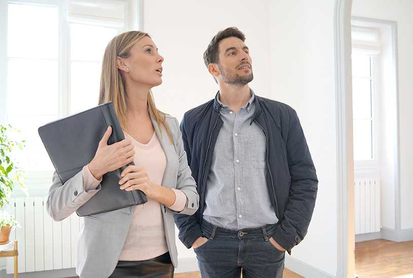 Two landlords looking at a property they're interested in buying
