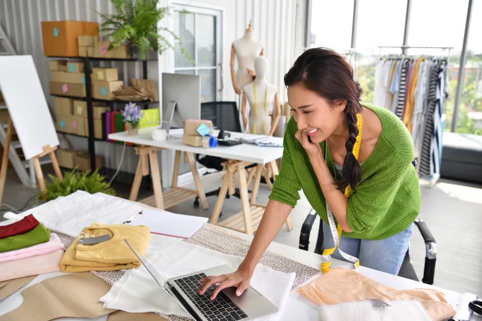 Woman smiling and taking online orders for a small business