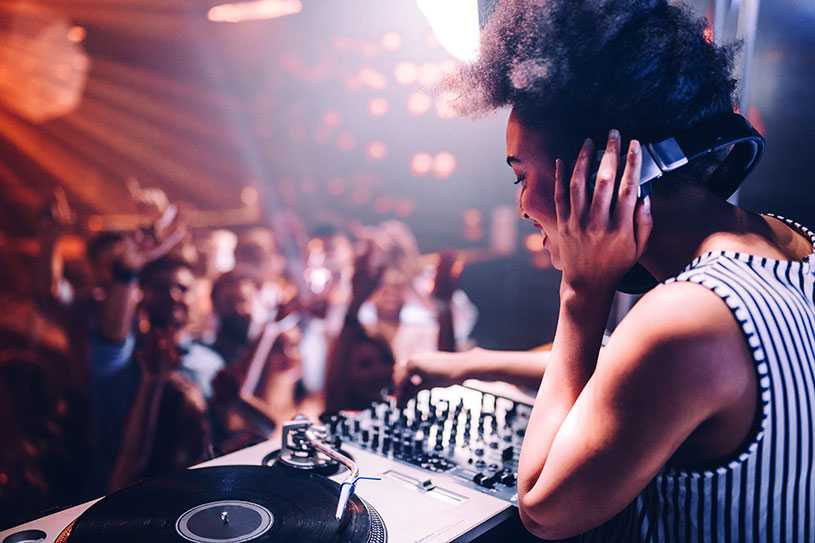 Woman DJing for a crowd